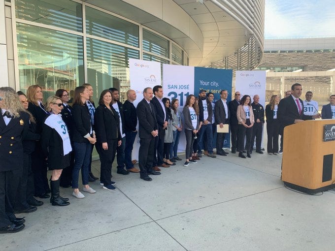 Local representatives standing in front of San Jose 311 banners.
