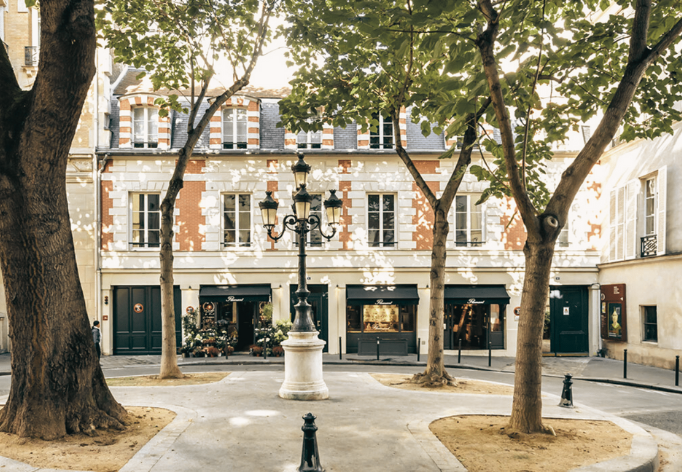 square in Paris with tree, lantern as traveller reflects on slow travel