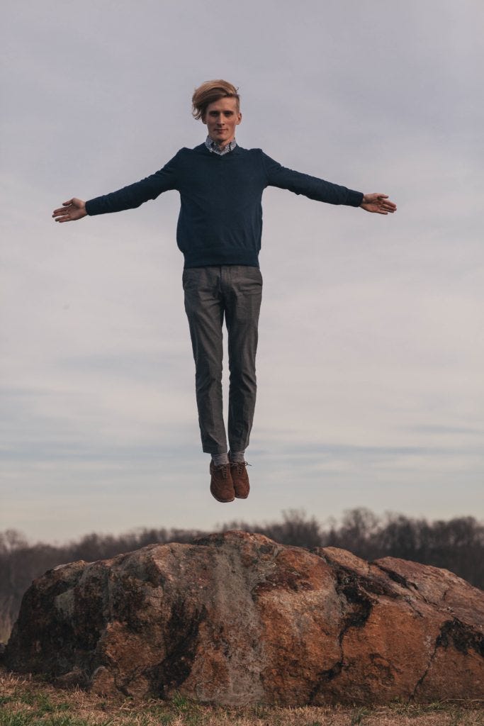 man-levitating-over-some-rocks