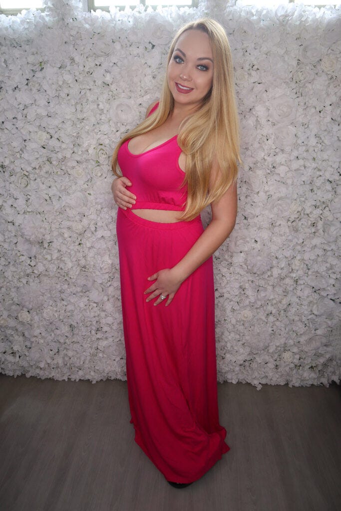 Woman in Bump Biddy Maternity Clothes Long Pink Dress