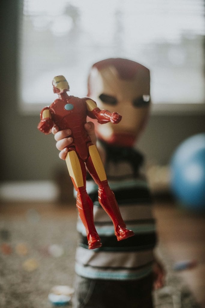 Child plays with Iron Man action figure.
