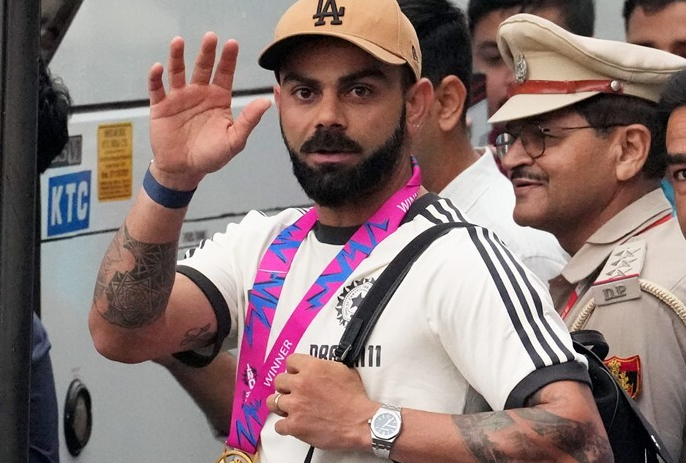 Cricketer Virat Kohli waves upon his arrival at New Delhi airport, Thursday, July 4, 2024. Indian cricket team returned home after India’s title-winning campaign at the ICC T20 World Cup 2024.