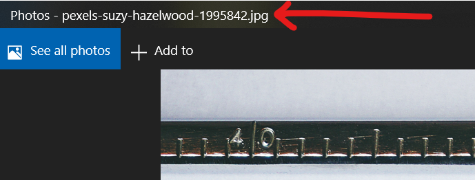 A red arrow pointing at the file name of a free image downloaded from Pexels.