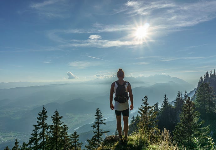 Hiker looking out on a mountain top “The Endeavor Haiku” by “Arthur G. Hernandez”