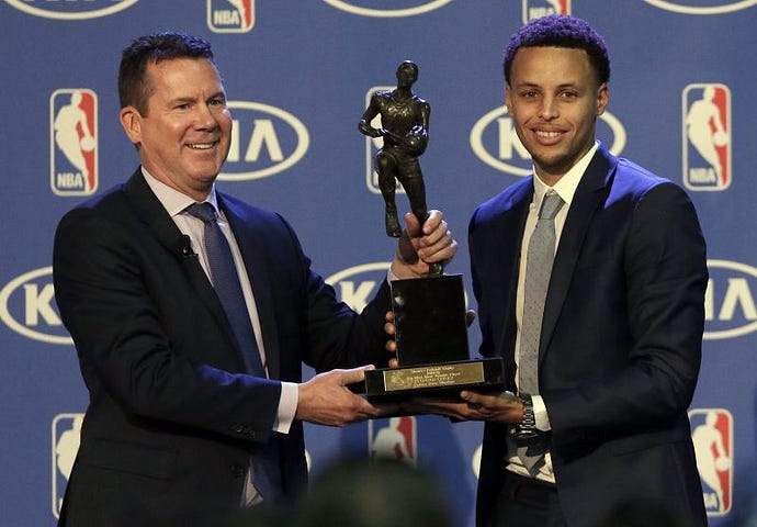 Golden_State_Warriors_point_guard_Stephen_Curry_is_presented_with_the_NBAs_Most_Valuable_Player__24624_13488