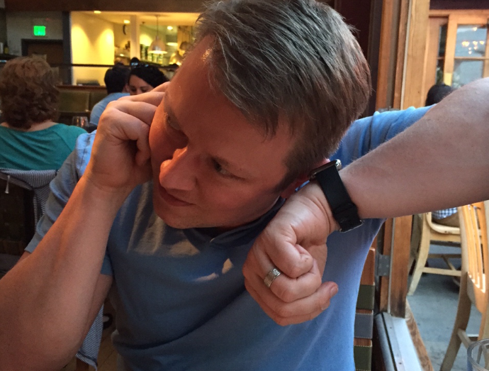 A man takes a call through his Apple Watch.