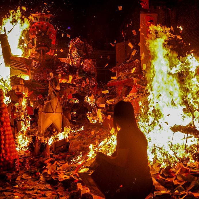 People burning joss paper to pray for good luck for the deceased during Ghost Festival in Kuala Lumpur, Malaysia