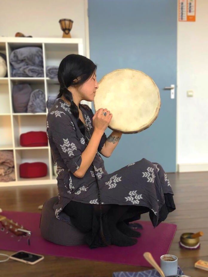 Photo of the author, Alice Ming, drumming & singing in a cacao ceremony