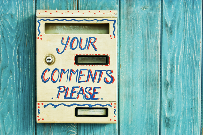 a drop box on a wall with the words “Your Comments Please” written on it