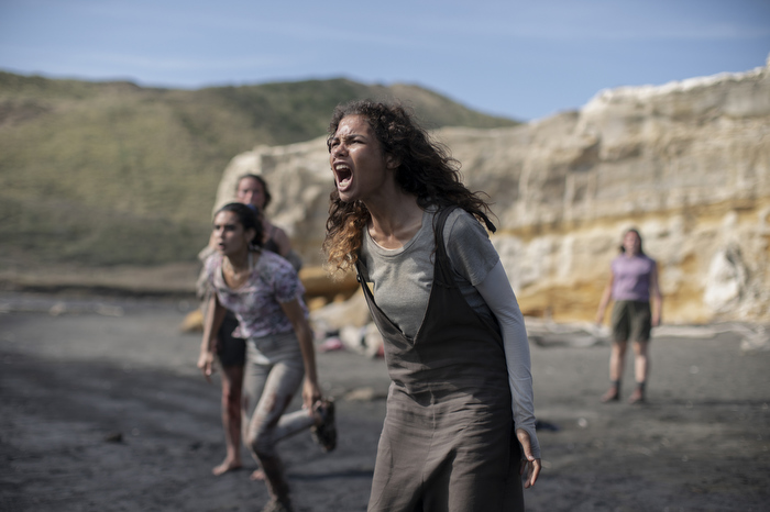 Nora screams and other characters run in the direction of the water where her sister has been spotted with a shark.