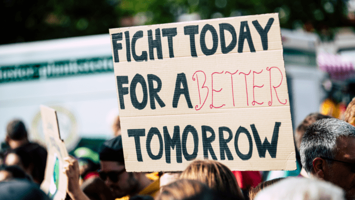 Protest with a sign reading “fight for a better tomorrow”