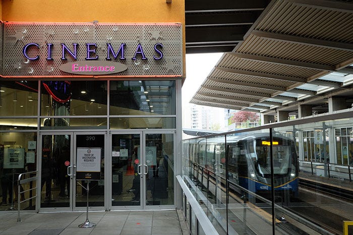 The entrance to a movie theatre in New Westminster, BC, located inside a SkyTrain station.