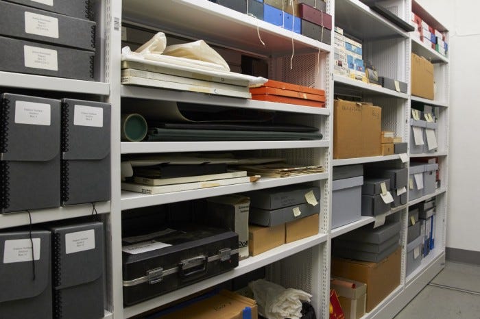 Photograph of archives in the John Rylands Library storage area. Shows boxes and folders.