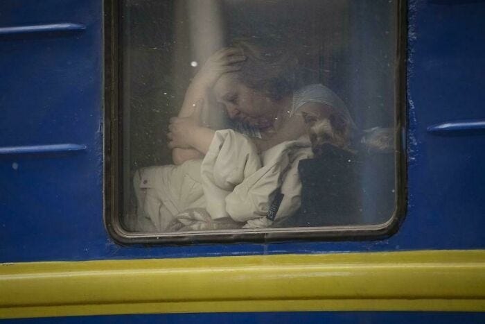 A woman sits by the window of a Lviv-bound train, in Kyiv, Ukraine.