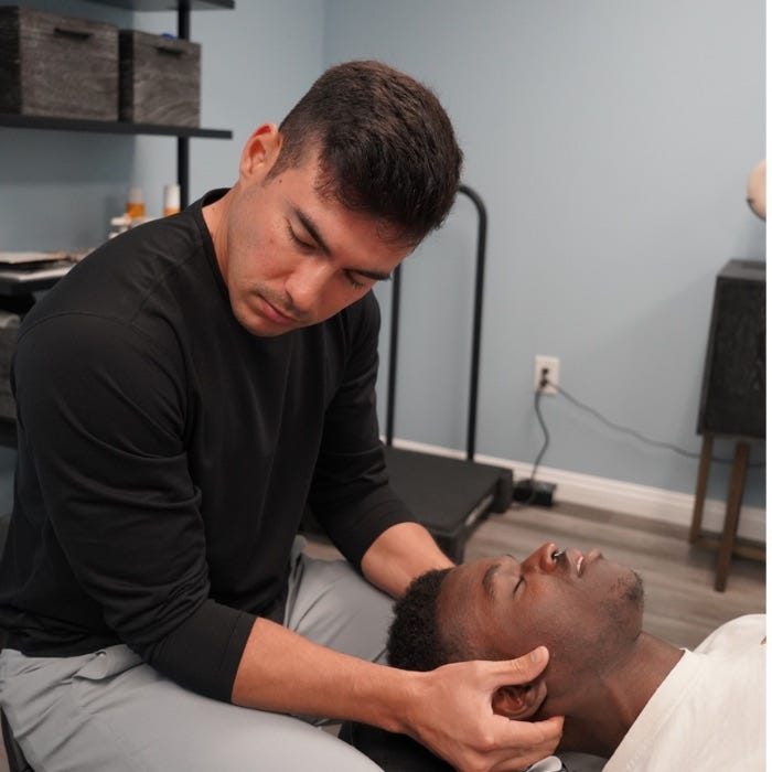 Tyler Bigenho performing chiropractic care on client
