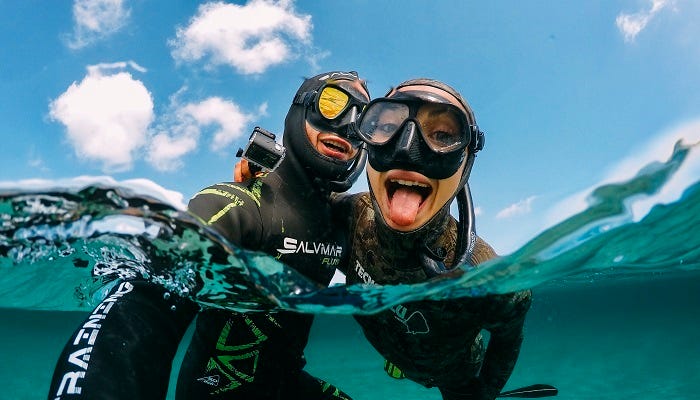 A couple swimming in the sea with a GoPro action camera
