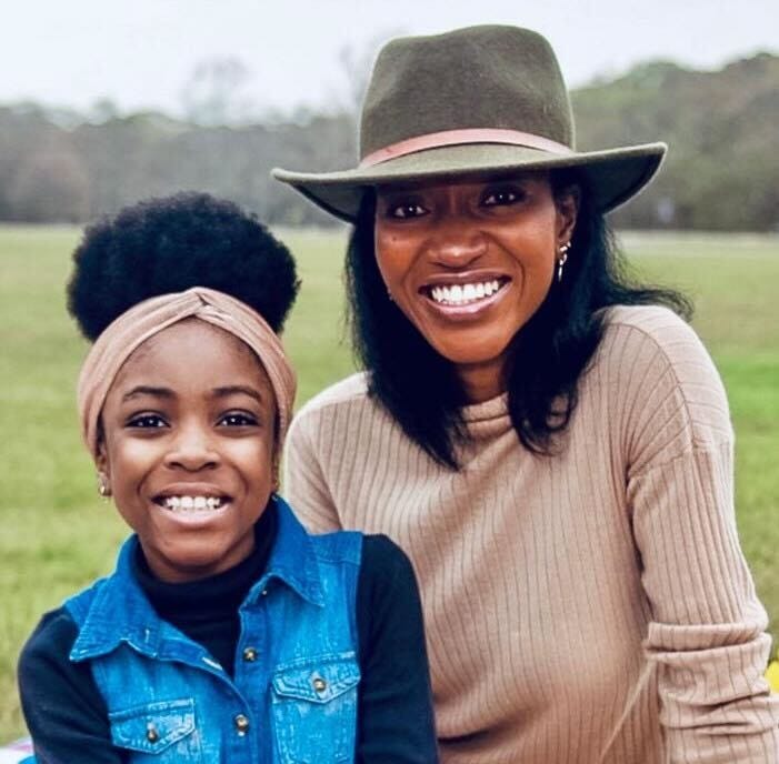Picture of Toyosi Babalola and her daughter at a park.
