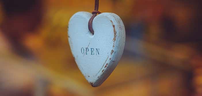 wooden heart hanging from strap with OPEN written on it