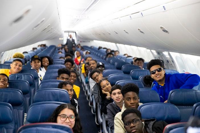 OBAP and ACE students posing on the plane.