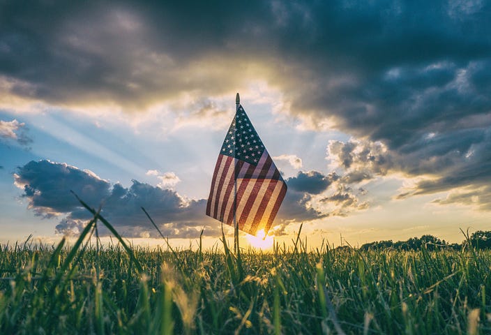 photo of flag in grass posted on Warrior Stories article by Lane Taylor, EIC Mickey Markoff