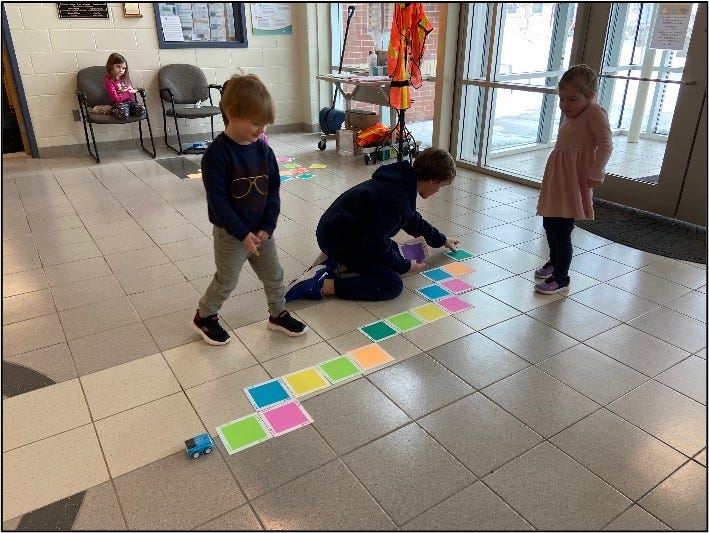 Two students working with their coding leader