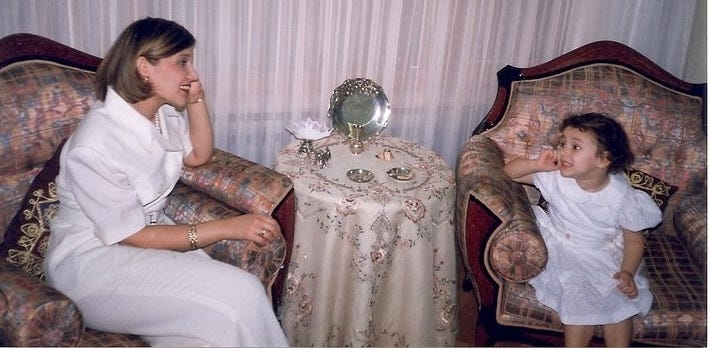 Mama and daughter are talking over an imaginary phone, 1998