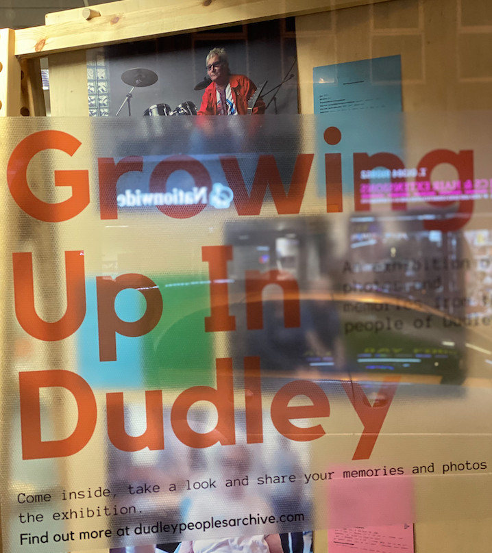 Photograph of CoLab Dudley window invitation to the Time Rebel led public exhibition on the High Street of the Growing Up in Dudley multi-medium community archiving project