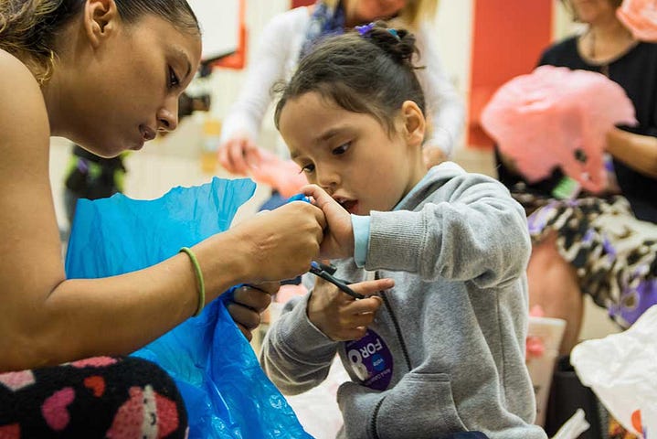 A parent and student work on an art activity at a recent family arts meets academics night hosted by PAA at Dunbar.