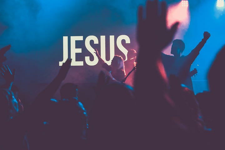 Young people worship Jesus, with hands raised in praise, develop spiritual fruit