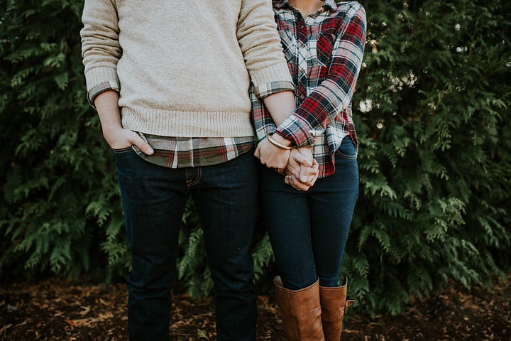 Man and woman holding hands in a park