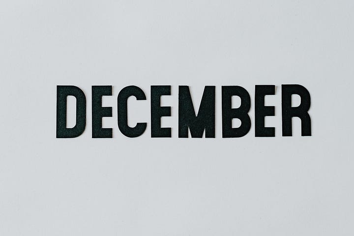 The word DECEMBER in bold black capitals on a grey background, signifying the end.