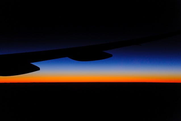 Dawn as seen through the window of a Boeing 777 during a flight from Sydney, Australia to Loas Angeles, California. (Kourosh Azar)