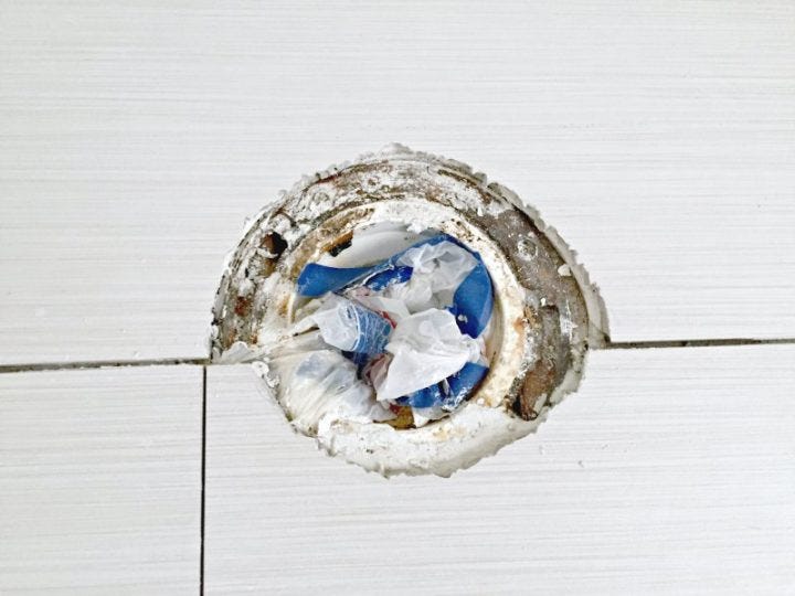 incorrect tile cut around toilet flange