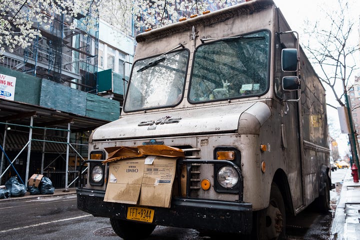 Dirty looking old delivery truck.