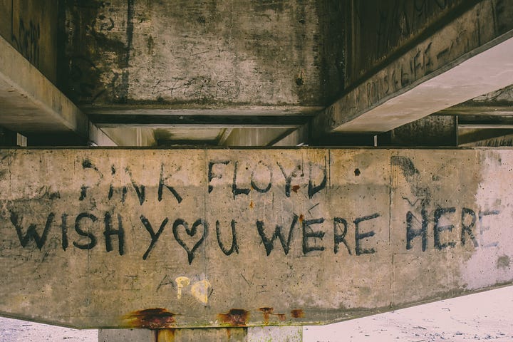 Graffitti on an underpass, saying Pink Floyd, wish you were here