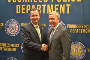 Voorhees Mayor Michael Mignogna, left, shakes hands with Evesham Mayor Randy Brown after announcing the Evesham Saving Lives free designated driver program was expanding to Voorhees.
