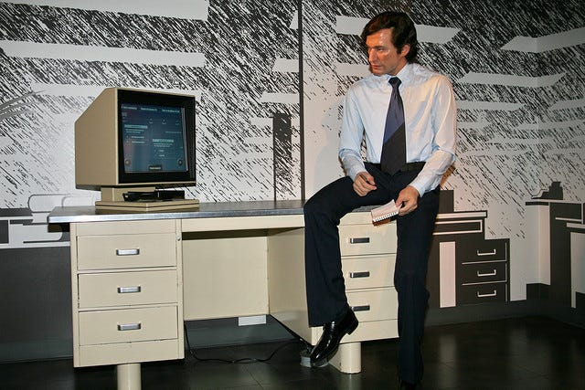 A wax dummy looking in wonder at a newsroom computer, forever.