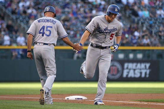 Corey Seager is congratulated by third-base coach Chris Woodward. (Doug Pensinger/Getty Images)