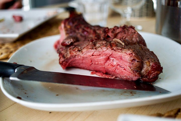 Extremely rare steak on a plate.