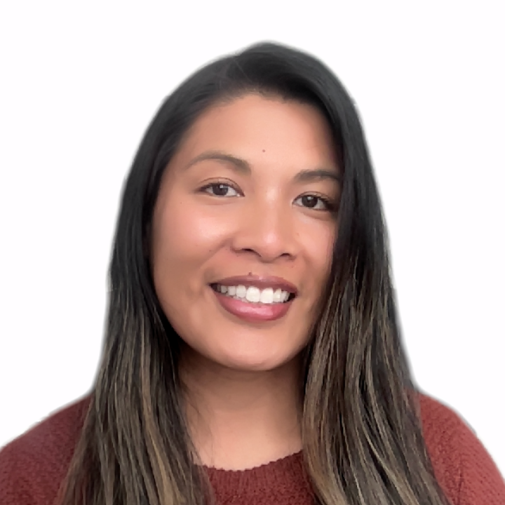 Headshot of Meia, who is looking towards the camera with an open-lipped smile. Meia is a Filipina-American with brown skin and black hair that is partially dyed blonde. She is wearing a red sweater.