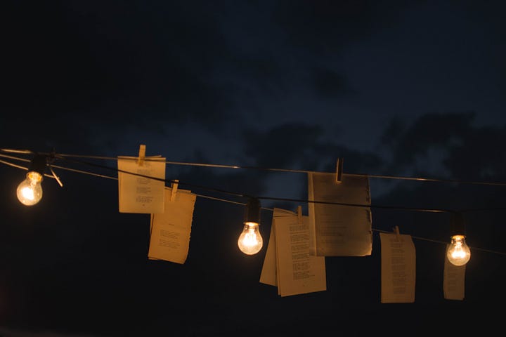 papers and candles at night hanging from a cord or rope