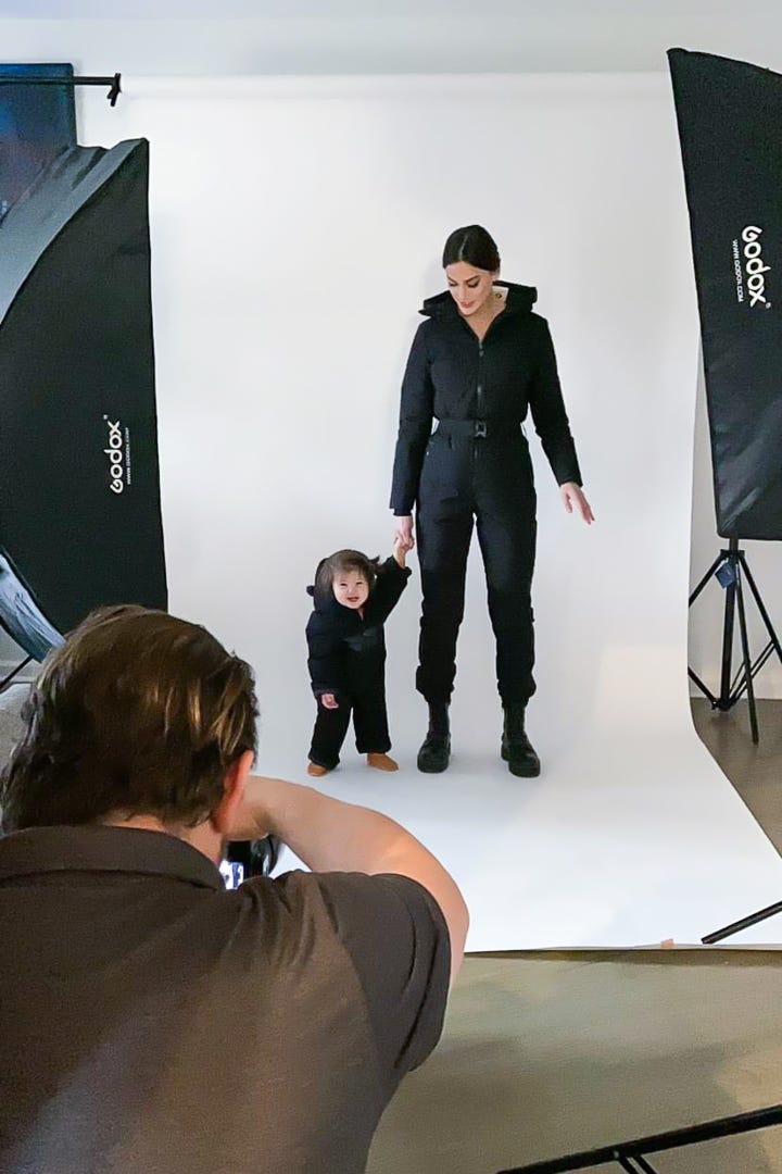 Adult model and child model posing for photographer