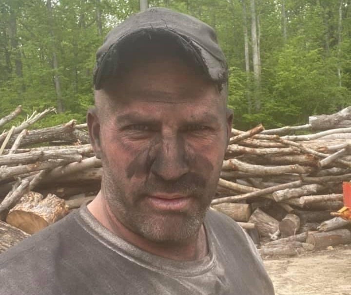 Image of Roland Daniel Pedro expertly felling trees in a forest while wearing protective gear