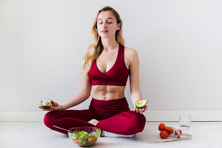 Woman eating on a yoga pose.