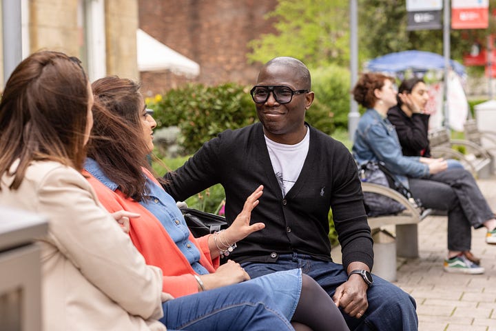 An image of LLC students of various ages socialising in an outdoor space at the University of Leeds.