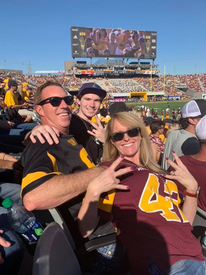 Karen photographed with her family, cheering on the ASU Sun Devil Football team.
