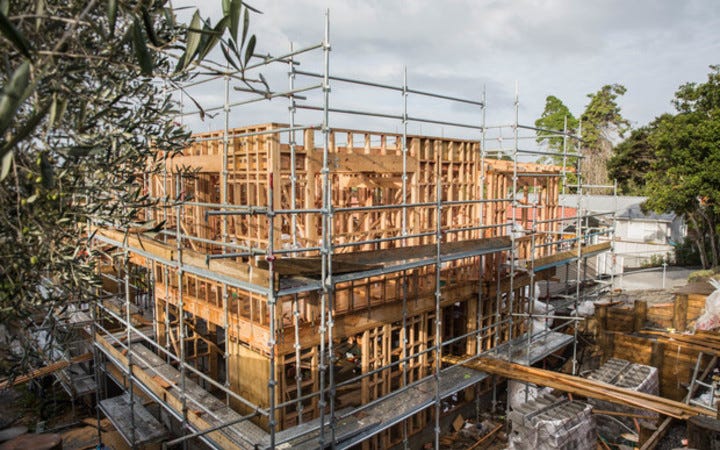 A timber frame of a three storey building under construction