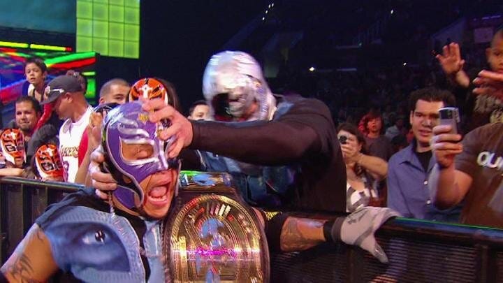 Chris Jericho attacking Rey while disguised as a fan