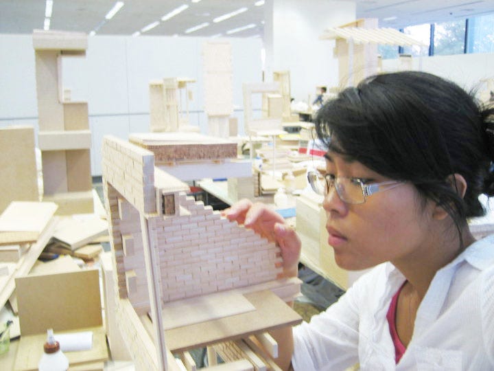 The author is building a physical architectural model in an undergraduate studio.