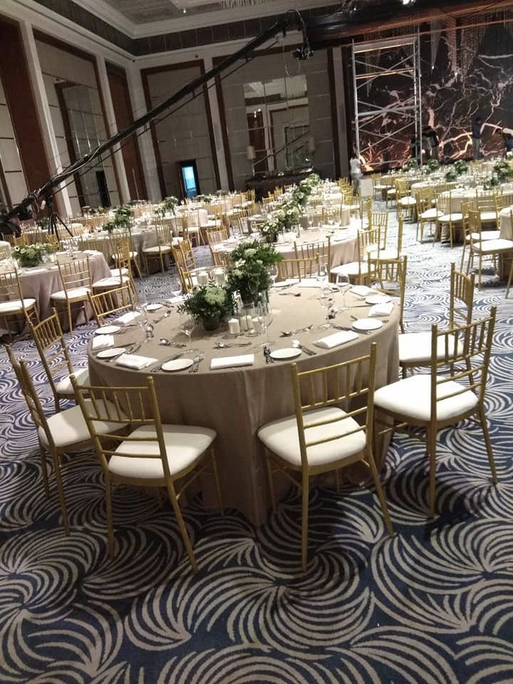 Gold Chiavari Chairs and Round Banquet Tables with Beige Covers for rent in Dubai, Abu Dhabi and UAE.